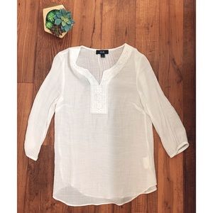 Thin white top with embroidery detail